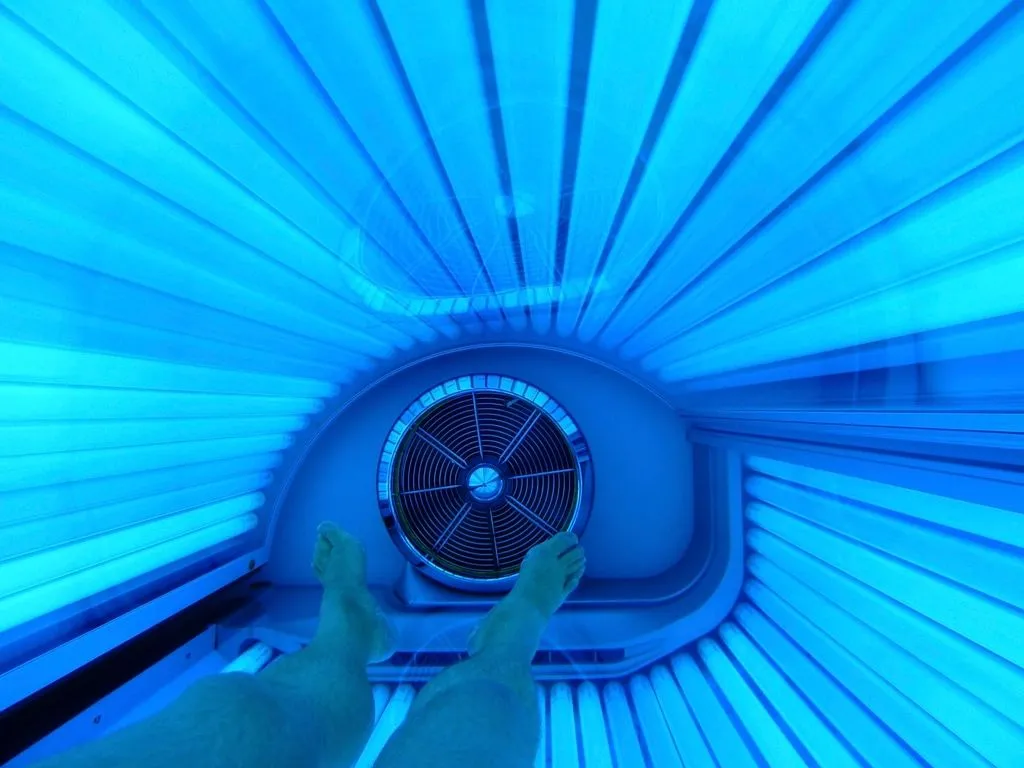 Inside a glowing tanning bed